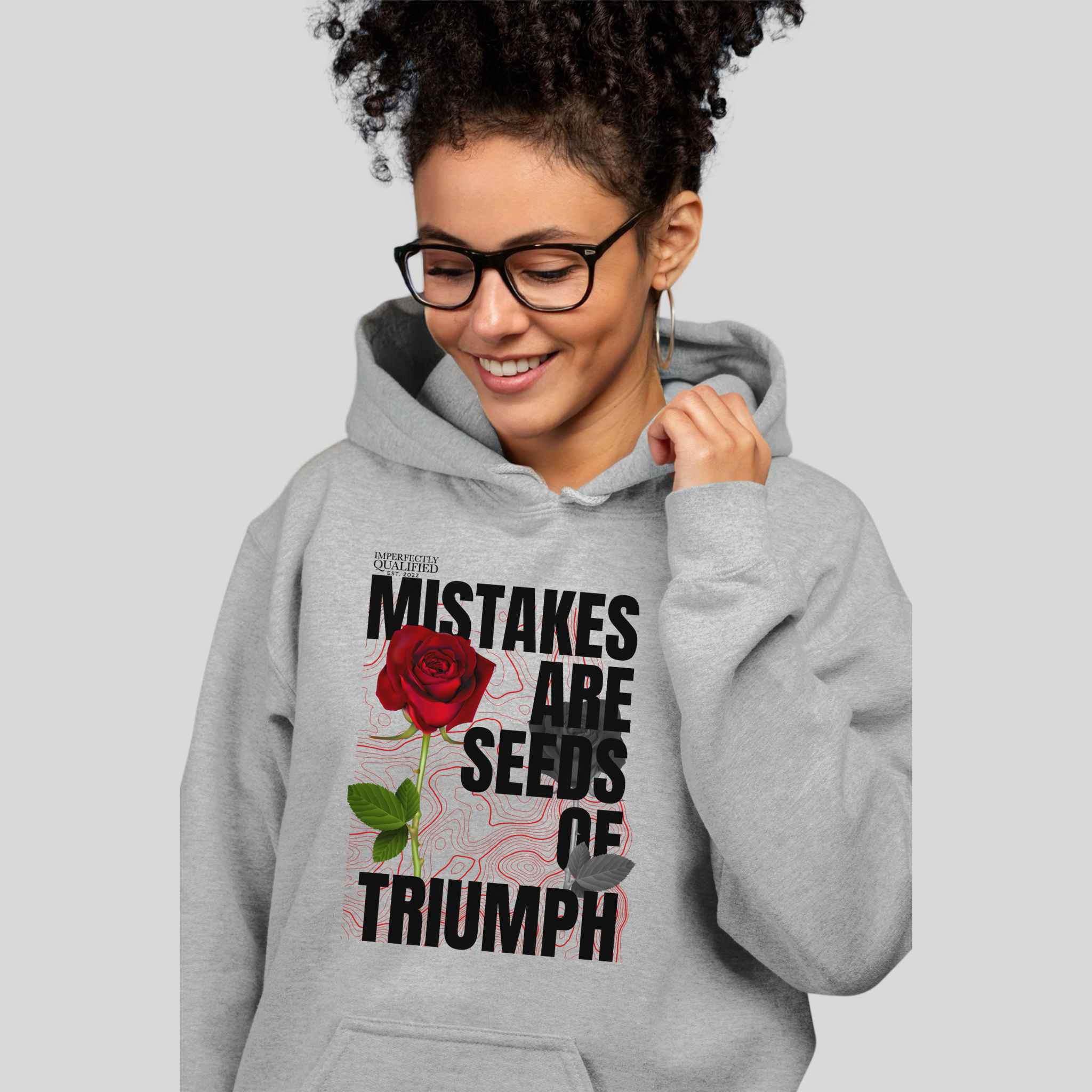 Heather Gray hoodie with motivational / inspirational phrase "Mistakes are Seeds of Triumph" in bold letters, creating a fashion statement that also carries a profound message.
